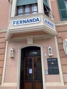 a building with a sign above a door at Hotel Fernanda in Rapallo