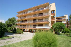 an apartment building with balconies and a yard at Mare Nostrum 223 in Torroella de Montgrí