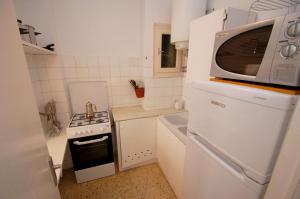 a small kitchen with a microwave on top of a refrigerator at Mare Nostrum 223 in Torroella de Montgrí
