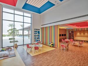 a room with a classroom with tables and chairs at Jumeirah Gulf of Bahrain in Manama