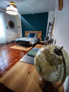a room with a bed and a globe on the floor at Le Loge'Mans Appartement proche gare , Tram et centre ville in Le Mans