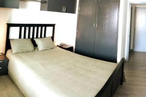 une chambre avec un grand lit avec une tête de lit noire dans l'établissement Casa de la Mama, à Parque Holandes