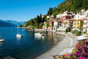 a group of houses on the shore of a body of water at Villa Rosa Perla - Lake Como - Schignano in Schignano