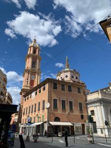 a building with a clock tower on a city street at Hotel Fernanda in Rapallo