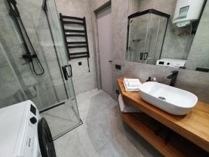 a bathroom with a sink and a shower at VIP studio in the center of Kyiv residential complex "Yaroslavov Grad" in Kyiv