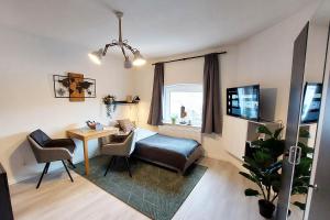 a room with a bed and a desk and a table at Apartment in Herne in Herne