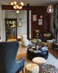 a living room with chairs and a table at Madrigal in Paris