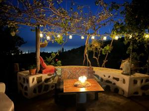 un patio con una mesa y luces por la noche en Lillys märchenhafte Finca Rural, en Granadilla de Abona