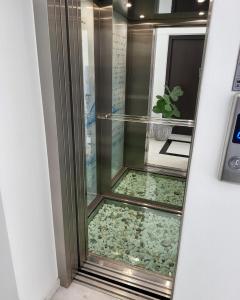 a glass door with a fish tank in a room at Melina Knossos Iraklio Crete in Áno Fortétsa