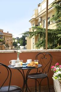 a table with a plate of food on a balcony at AlbaDomus Affittacamere in Rome