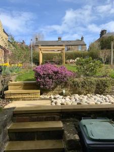 a garden with a gazebo and some rocks at A beautiful 1 bedroom home. in Matlock