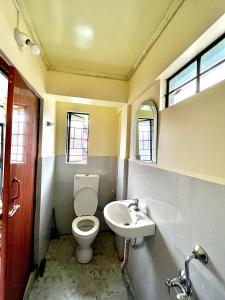 a bathroom with a toilet and a sink at HEEMSTEDE in Shillong