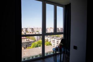 a view of a city from a window at Дизайнерські апартаменти в ЖК DreamTown 10а in Lutsk