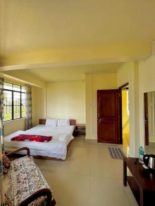 a bedroom with a bed and a couch in it at HEEMSTEDE in Shillong +14 photos