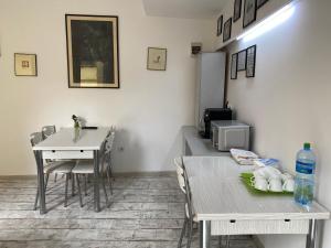 a dining room with a table and a table and chairs at B&B Duo Caffe in Bucharest