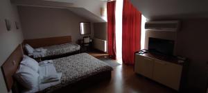 A bed or beds in a room at Restoran Filipovic