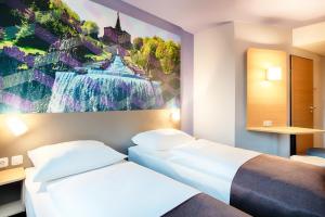 Postel nebo postele na pokoji v ubytování B&B Hotel Kassel-Süd