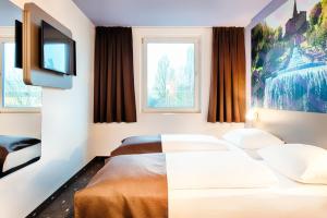 Postel nebo postele na pokoji v ubytování B&B Hotel Kassel-Süd