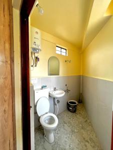a bathroom with a toilet and a sink at HEEMSTEDE in Shillong