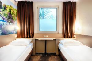 Postel nebo postele na pokoji v ubytování B&B Hotel Kassel-Süd
