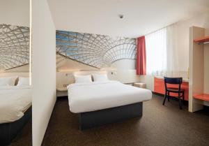 Postel nebo postele na pokoji v ubytování B&B HOTEL Katowice Centrum
