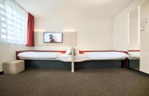 Postel nebo postele na pokoji v ubytování B&B HOTEL Katowice Centrum