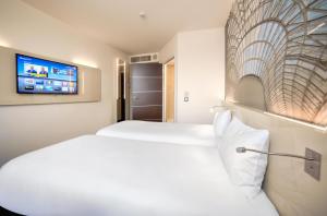 Postel nebo postele na pokoji v ubytování B&B HOTEL Katowice Centrum