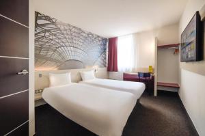 Postel nebo postele na pokoji v ubytování B&B HOTEL Katowice Centrum