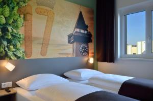 Łóżko lub łóżka w pokoju w obiekcie B&B Hotel Graz City-Süd