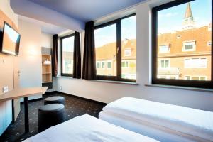 Postel nebo postele na pokoji v ubytování B&B Hotel Kiel-Holstenbrücke