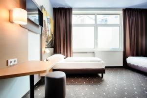 Postel nebo postele na pokoji v ubytování B&B Hotel Kiel-Holstenbrücke