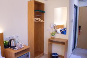 a room with a kitchen with a counter and a mirror at Astar Hotel Bukit Bintang in Kuala Lumpur