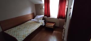 A bed or beds in a room at Restoran Filipovic