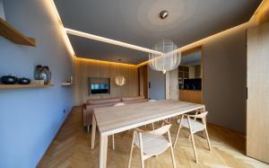 a dining room with a wooden table and chairs at Core Luxembourg City-Grand Duke's Palace in Luxembourg