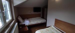 A bed or beds in a room at Restoran Filipovic