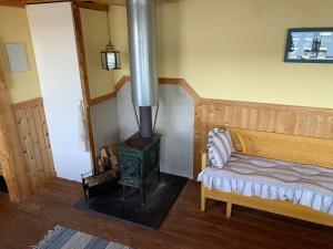 a bedroom with a wood stove in a room at Sävsjön in Mjöbäck
