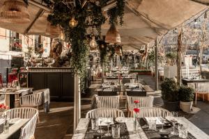 a restaurant with tables and chairs and plants at Hospes Puerta de Alcalá, a Member of Design Hotels in Madrid
