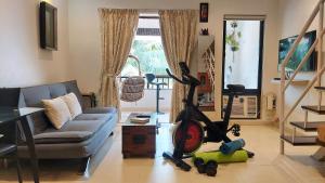 a living room with a couch and a vacuum at Susegad Suites Goa Apartments & Villas Riviera Hermitage Arpora in Arpora