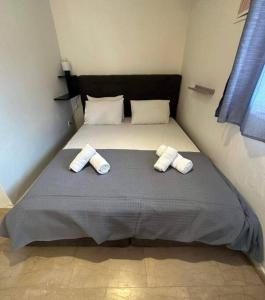 a bedroom with a bed with two towels on it at Mon Repo Apartment Corfu in Corfu Town