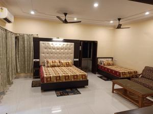a living room with two beds and a couch at Scindhia Guest House in Varanasi
