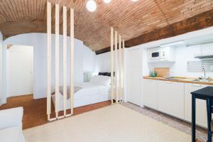 a room with a bed and a kitchen at BERGAMO art - PORTA AGOSTINO in Bergamo