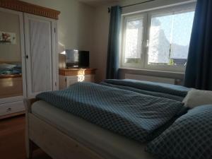 1 dormitorio con 2 camas y ventana en Ferienwohnung Sterl 13 en Herscheid