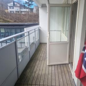 an open door on a balcony with a balcony at Laksevåg Apartment in Bergen