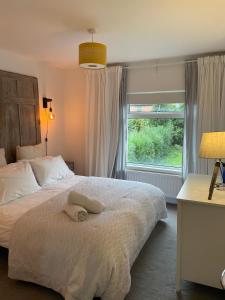 a bedroom with a large bed and a window at Cyprus View Apartment 2 in Belfast