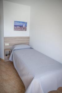 Posteľ alebo postele v izbe v ubytovaní Apartamentos pilucha