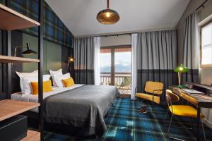 a hotel room with a bed and a desk at Chalet Alpen Valley, Mont-Blanc in Combloux