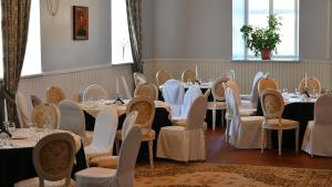 a row of tables and chairs in a room at Palmse Distillery Guesthouse - Self Check-in in Palmse