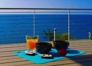 a tray with two bowls and a glass of orange juice at Bellavista in San Lorenzo al Mare