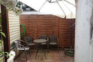a patio with chairs and a table and an umbrella at U Pani Marioli in Hel