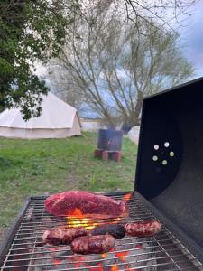 a grill with some meat on top of it at Rivers View Holidays in Westbury on Severn